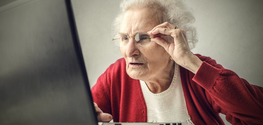 Confused grandmother using a pc